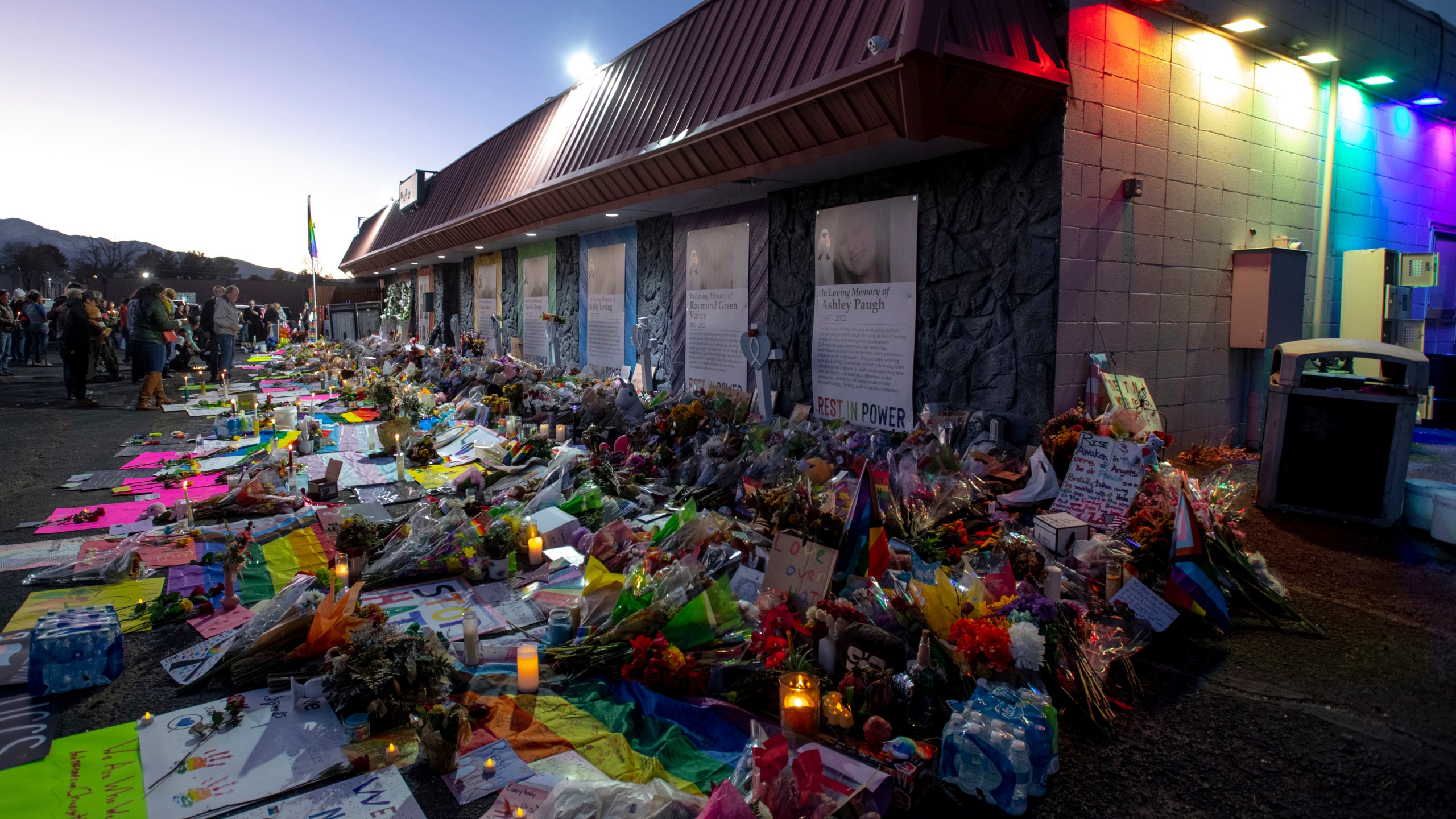 Mourners gather outside Club Q to visit a memorial