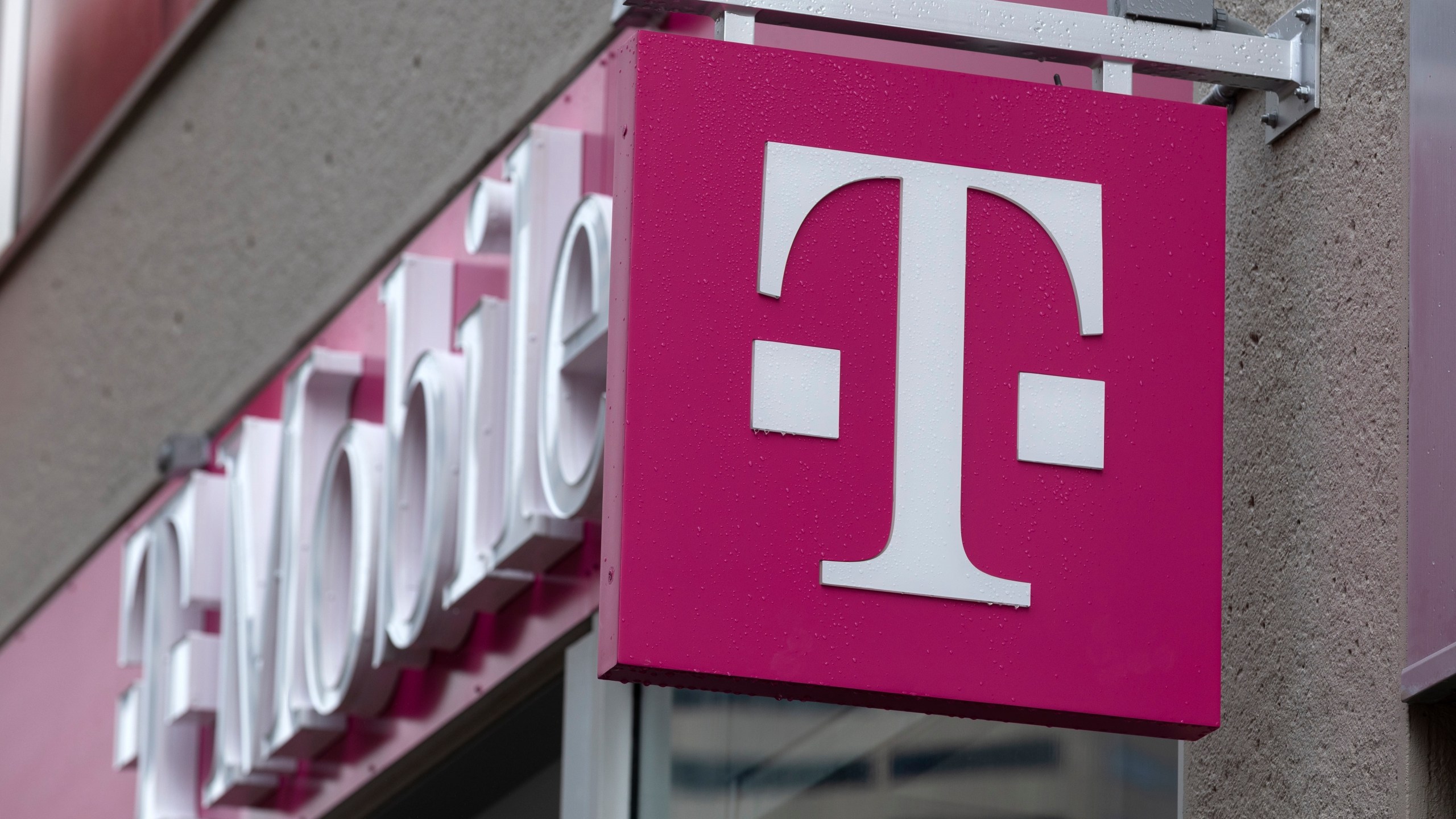 The T-Mobile logo is seen on a storefront