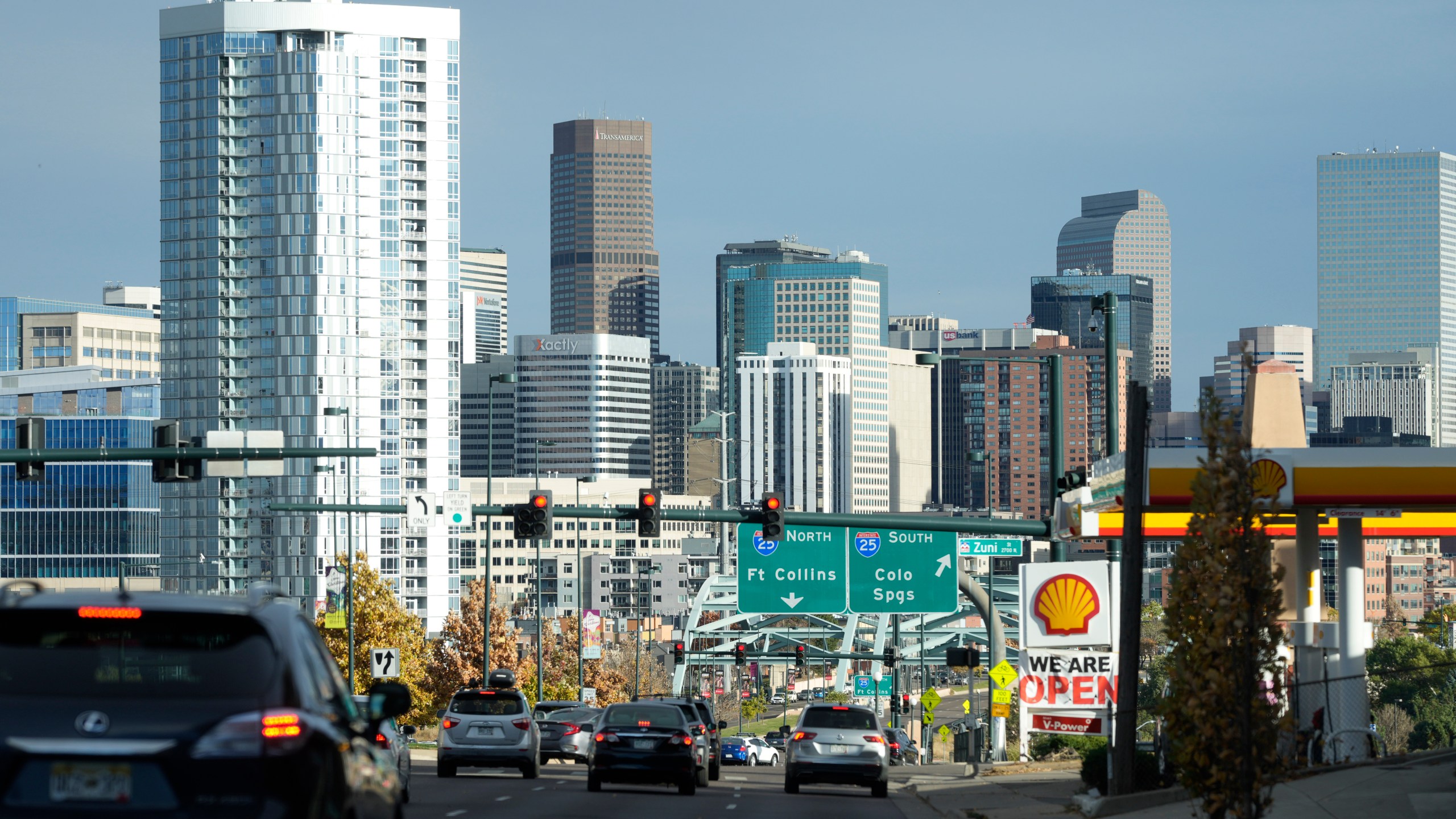 Motorists head eastbound along Speer Boulevard toward the skyline of downtown