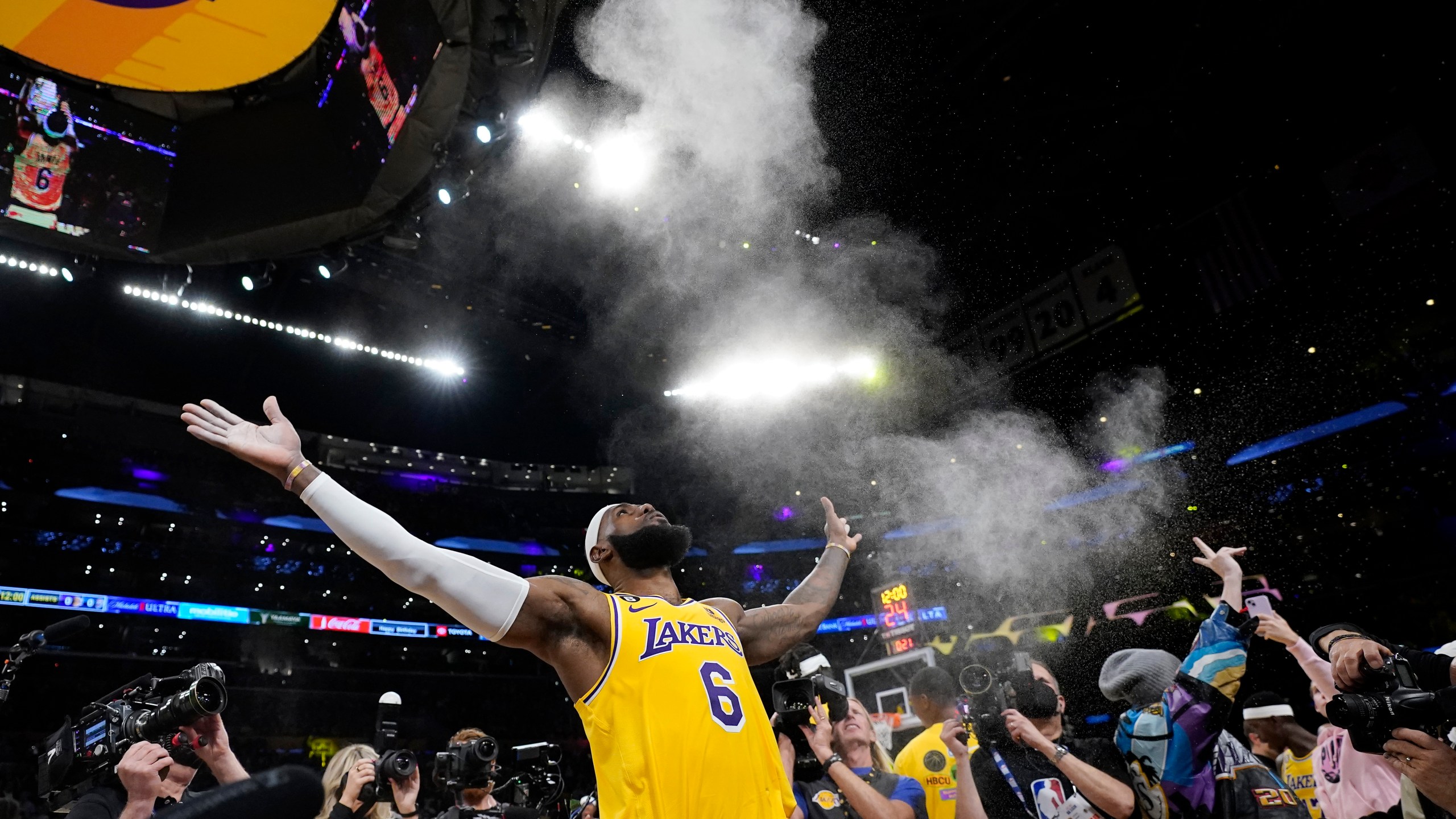 Los Angeles Lakers forward LeBron James tosses powder in the air