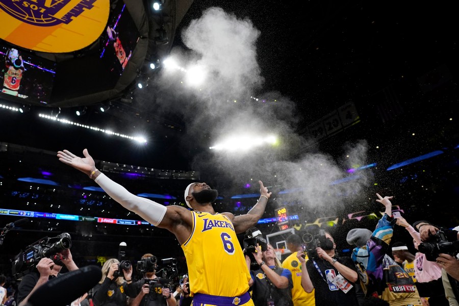 Los Angeles Lakers forward LeBron James tosses powder in the air