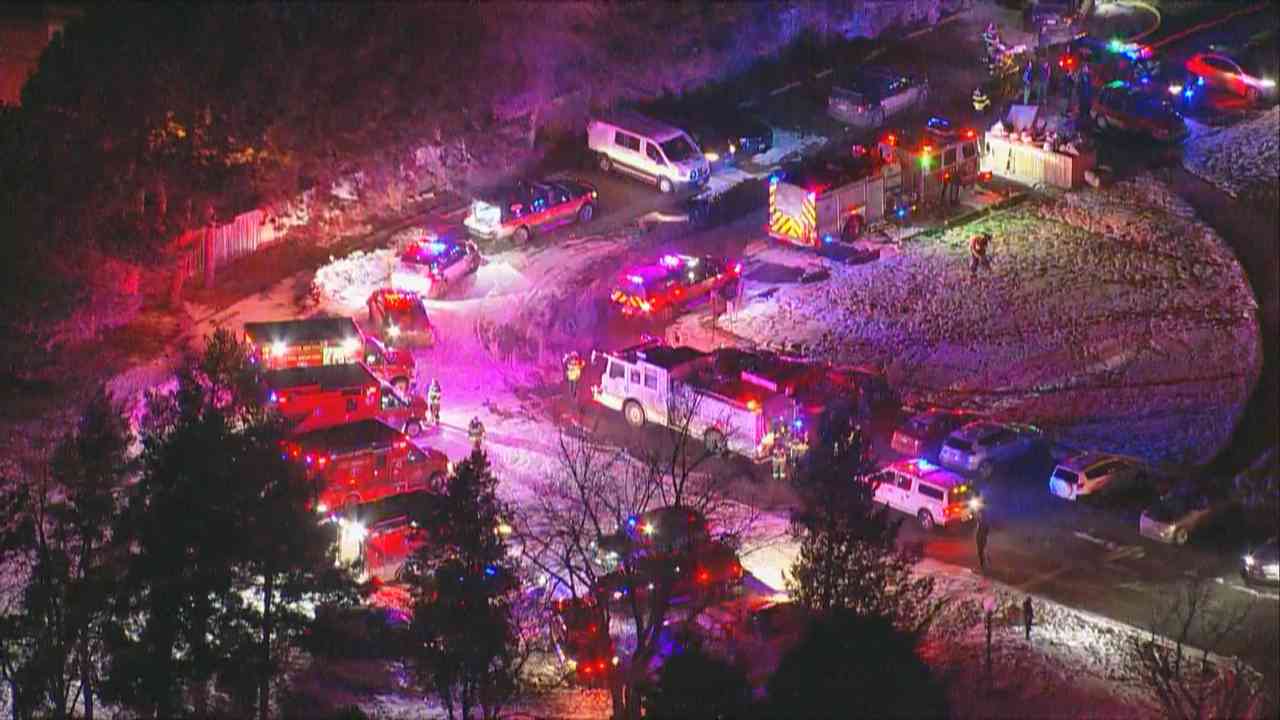 Aerial view of large emergency response at an apartment complex at night