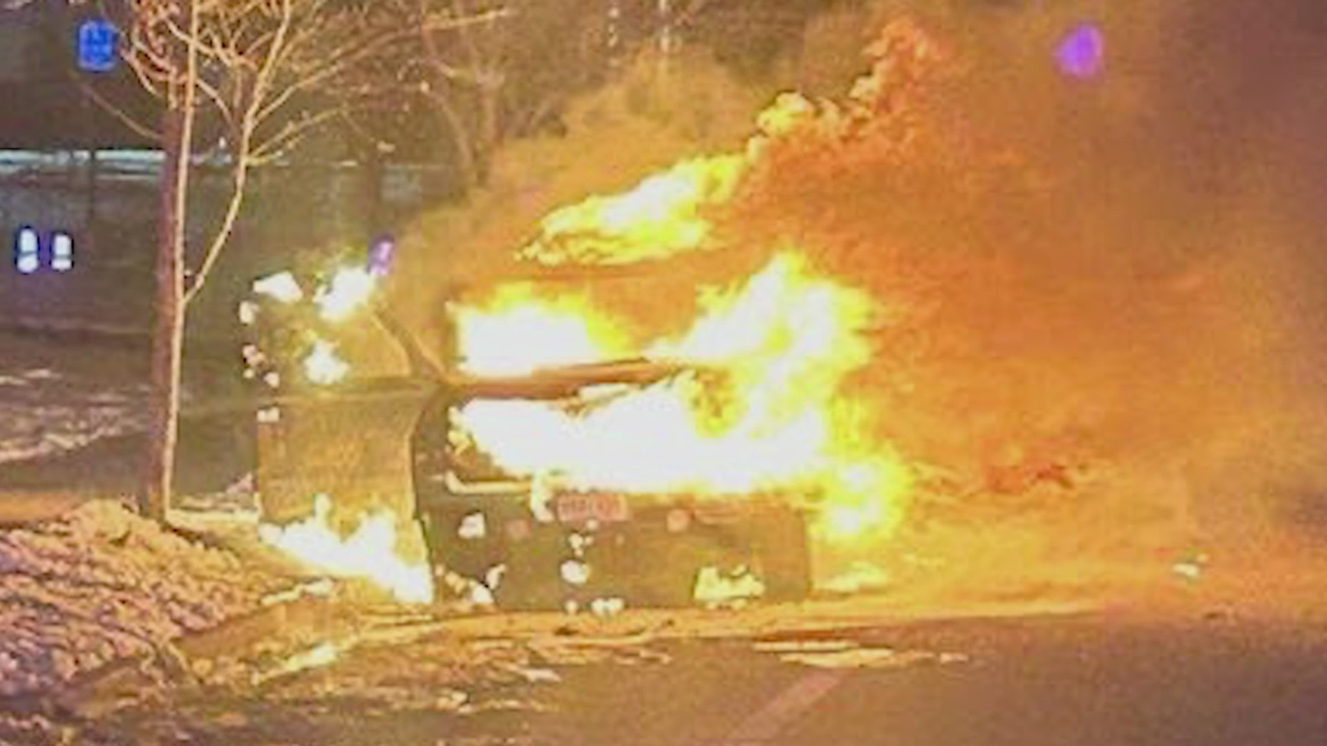 An SUV up in flames on the roadside