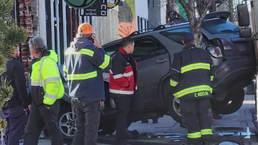 A Lexus SUV crashed into the front of a business with fire personnel responding