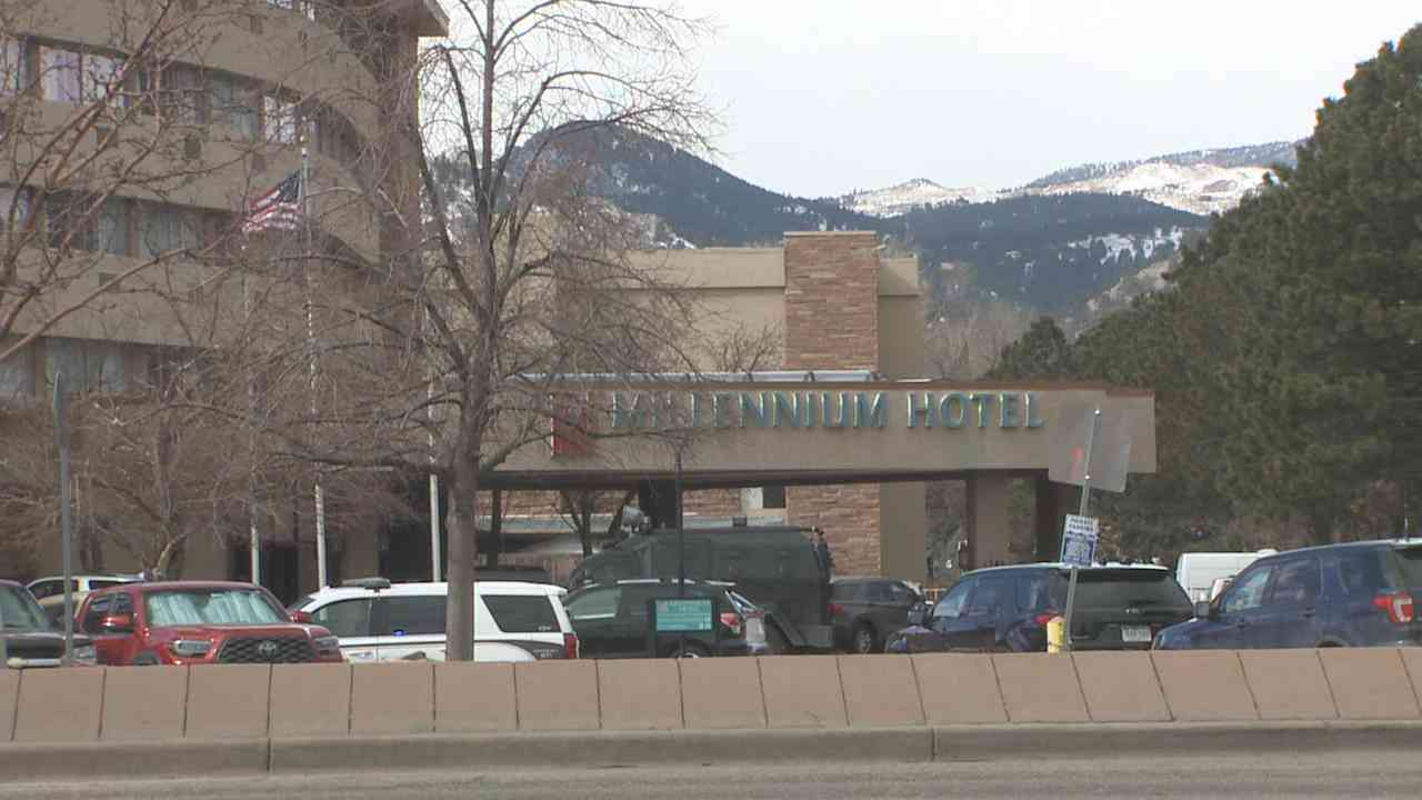 Exterior of the Millennium Hotel in Boulder with multiple police vehicles