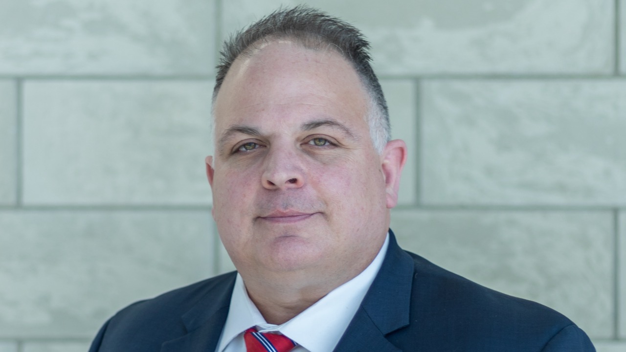 Darrel Guadnola headshot in suit and tie