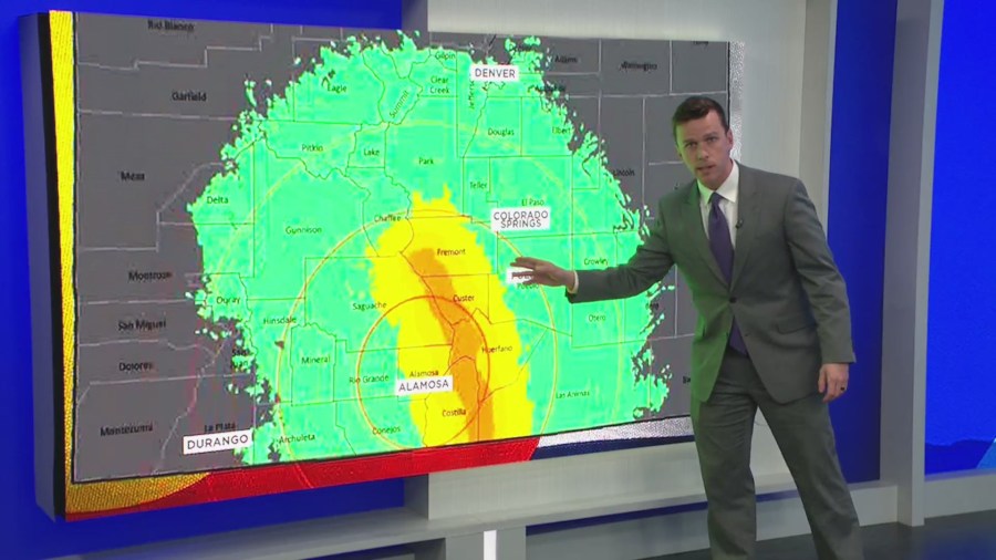 Alex Rose presents a Colorado Geological Survey map showing possible earthquake impacts near Alamosa and radiating out to Denver and Durango