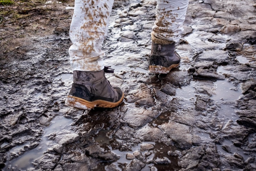 Splashing and melting snow drops on white jeans.