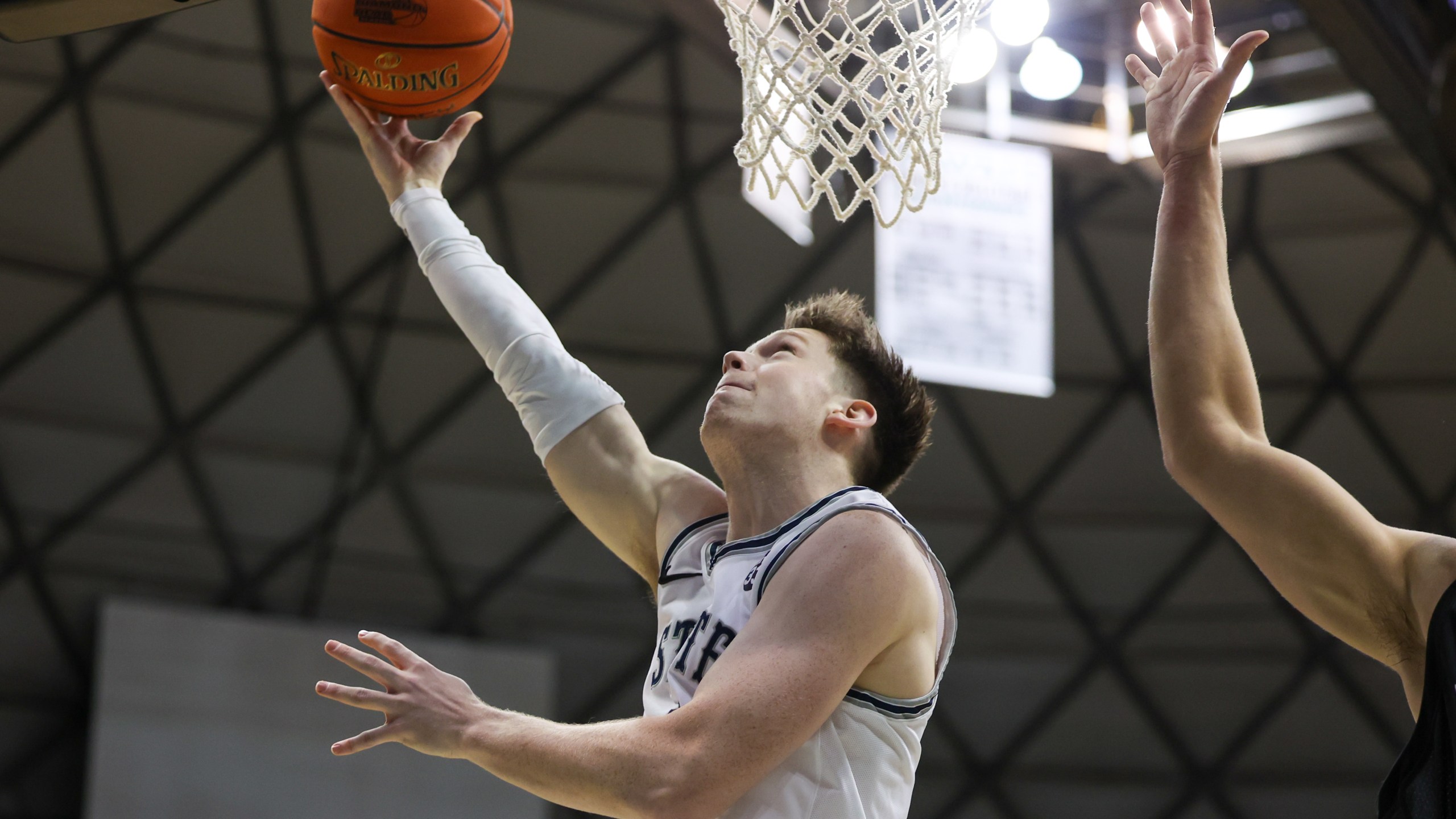 HONOLULU, HI - DECEMBER 22: Max Shulga #11 of the Utah State Aggies throws in a reverse layup.