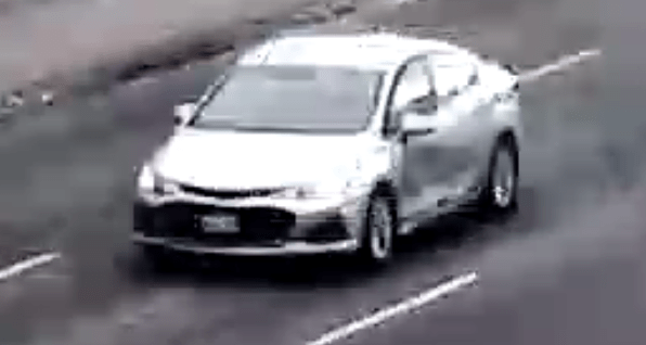 Surveillance image of a damaged silver Toyota Corolla