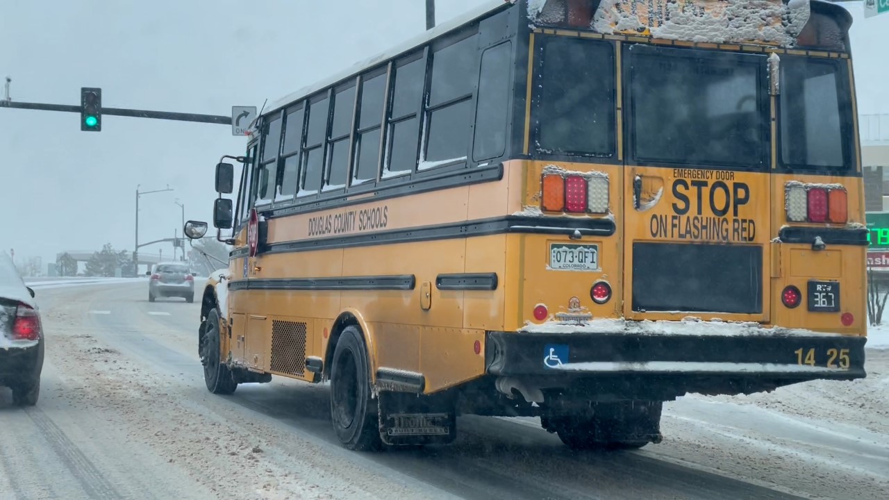 A Douglas County School District bus on a snowy road