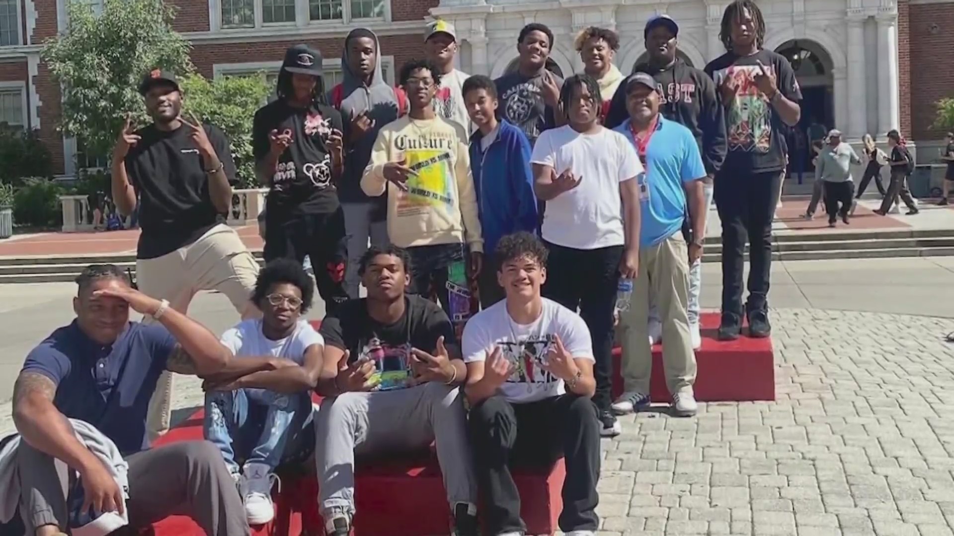 A group of more than a dozen Black high schoolers smile for the camera