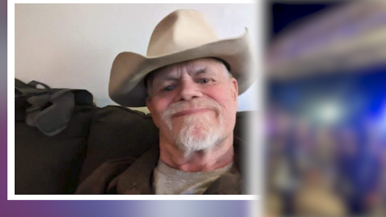 Close-up photo of a man with a goatee, mustache and cowboy hat