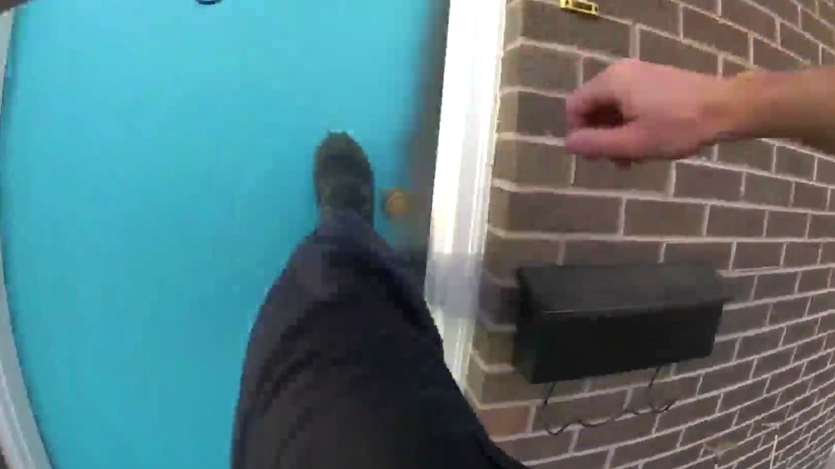 A Longmont police officer kicks in a door to help rescue residents from an apartment fire.