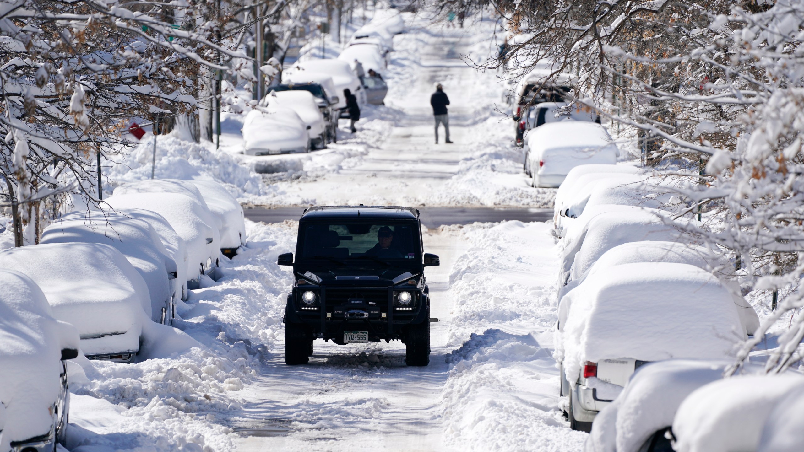 A sports-utility vehicle climbs Pearl Street after a major storm dumped up to two feet of snow