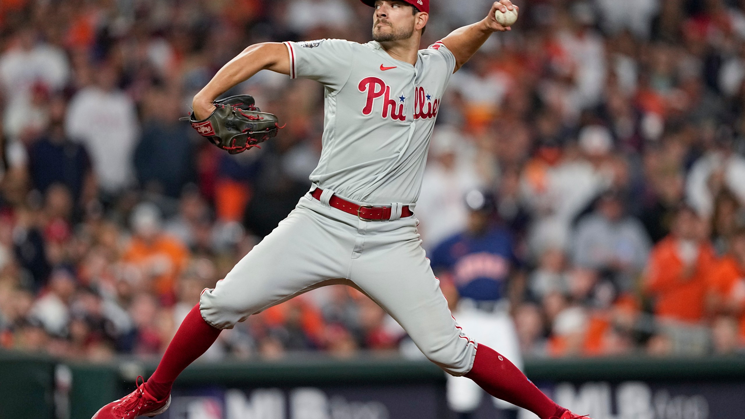 Philadelphia Phillies relief pitcher Brad Hand with his pitching arm cocked back mid-pitch