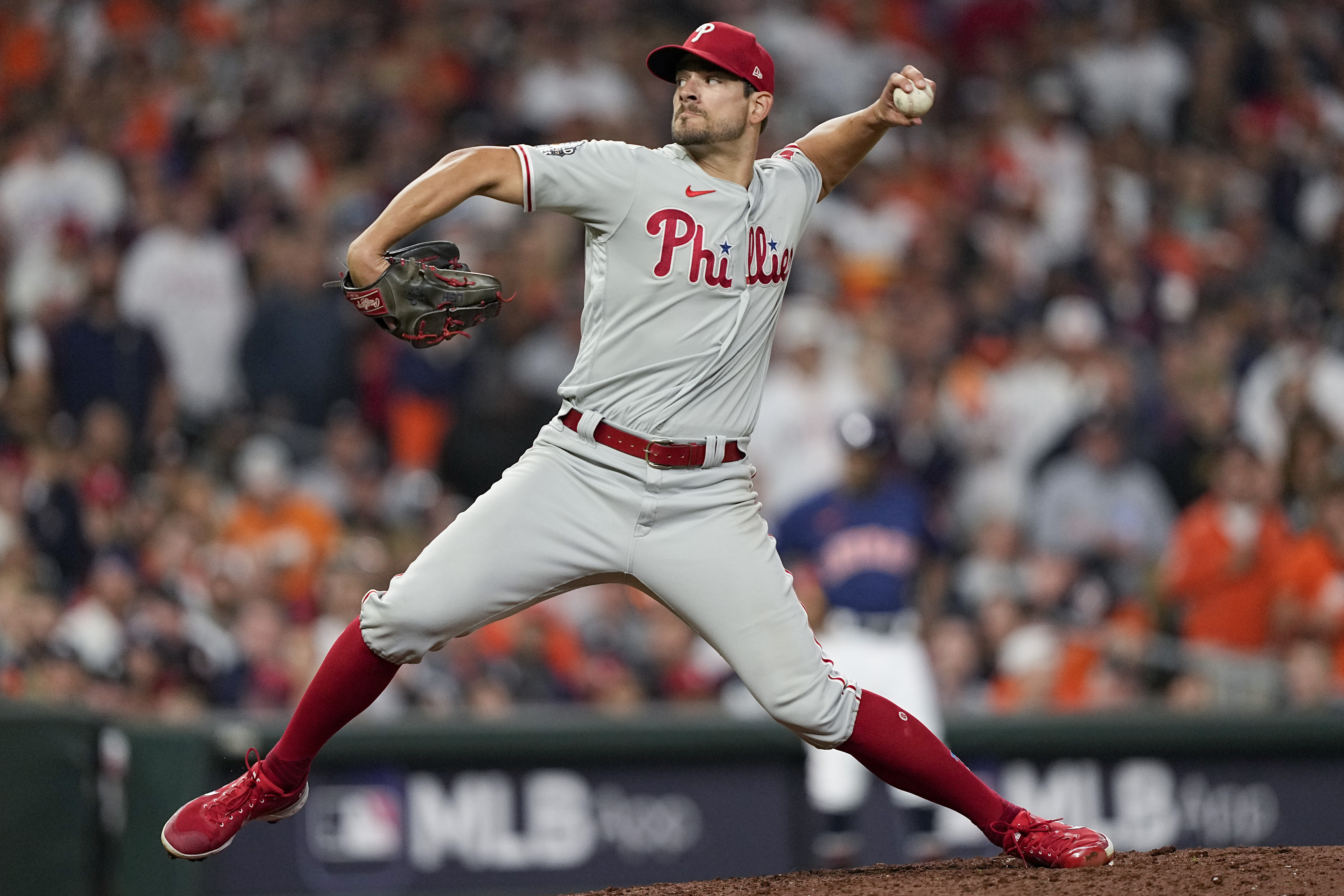 Philadelphia Phillies relief pitcher Brad Hand with his pitching arm cocked back mid-pitch