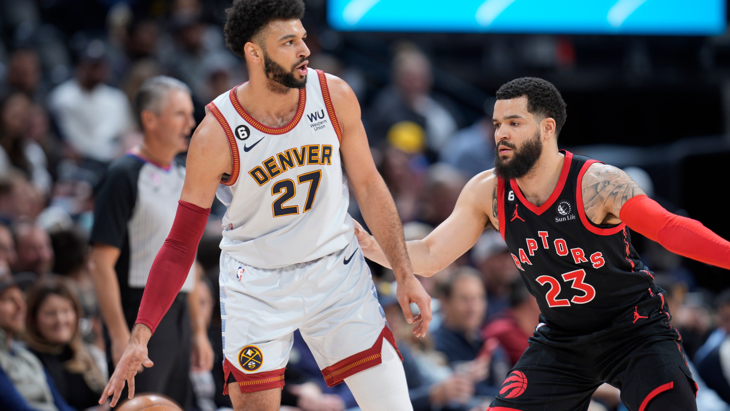 Denver Nuggets guard Jamal Murray, left, looks to pass the ball as Toronto Raptors guard Fred VanVleet defends