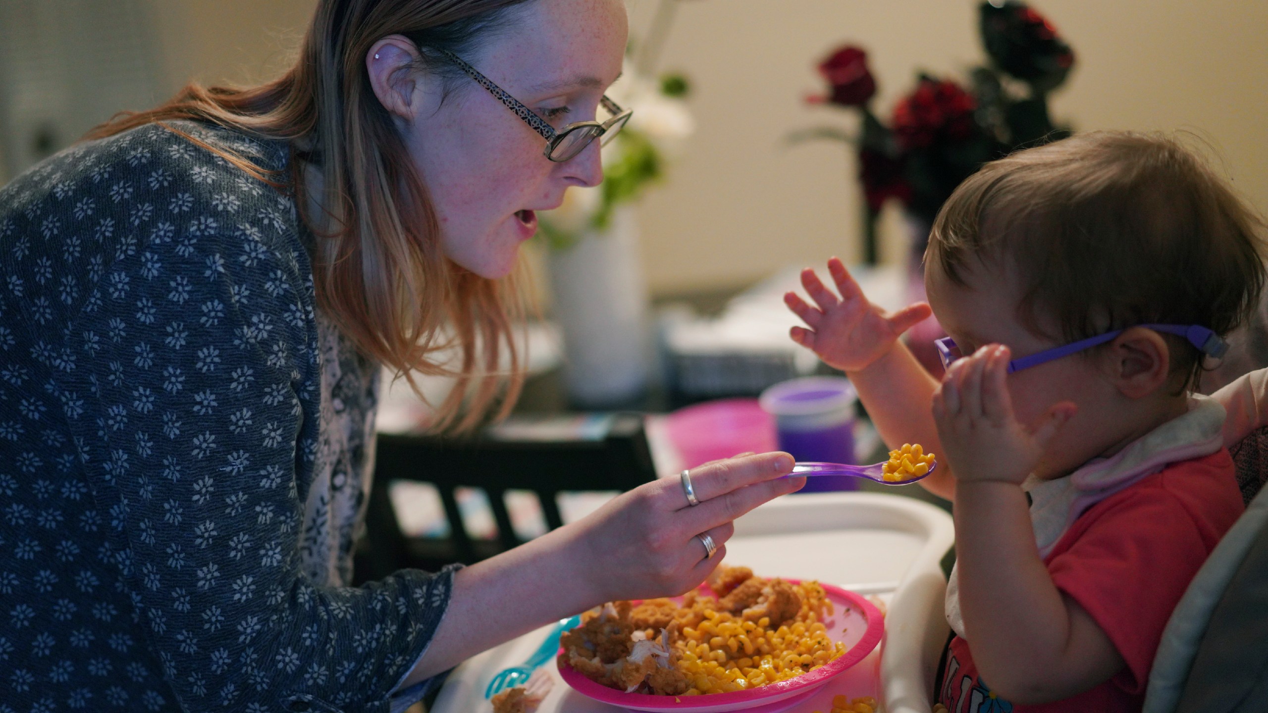 Lauren Hackney feeds her 1-year-old daughter chicken and macaroni during a supervised visit at their apartment