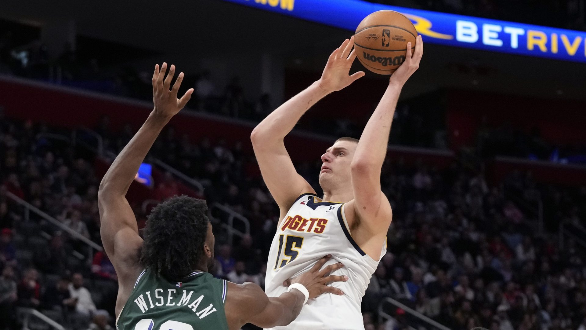 Denver Nuggets center Nikola Jokic (15) shoots over Detroit Pistons center James Wiseman (13)