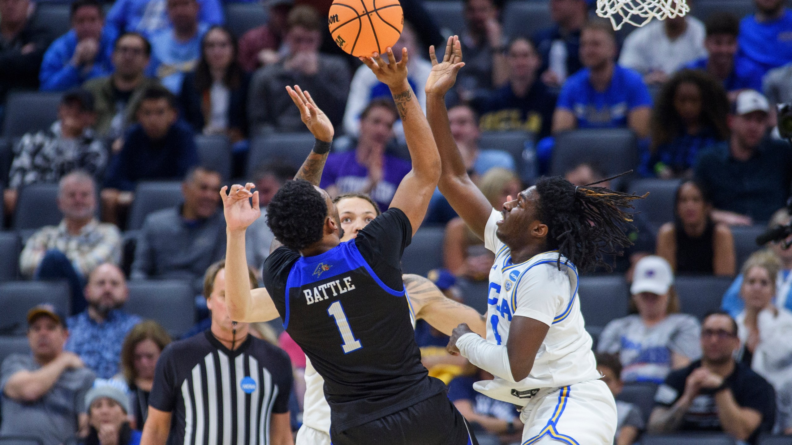 UNC Asheville forward Jamon Battle (1) shoots over UCLA guard Will McClendon (4)