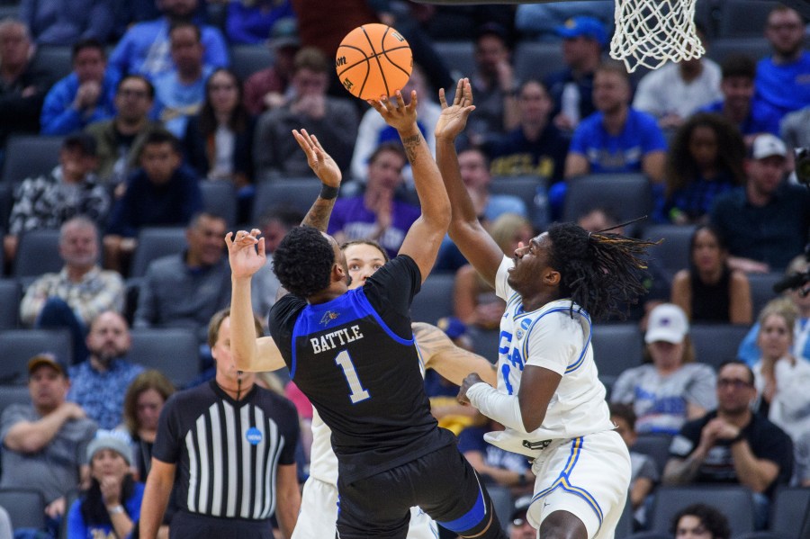 UNC Asheville forward Jamon Battle (1) shoots over UCLA guard Will McClendon (4)