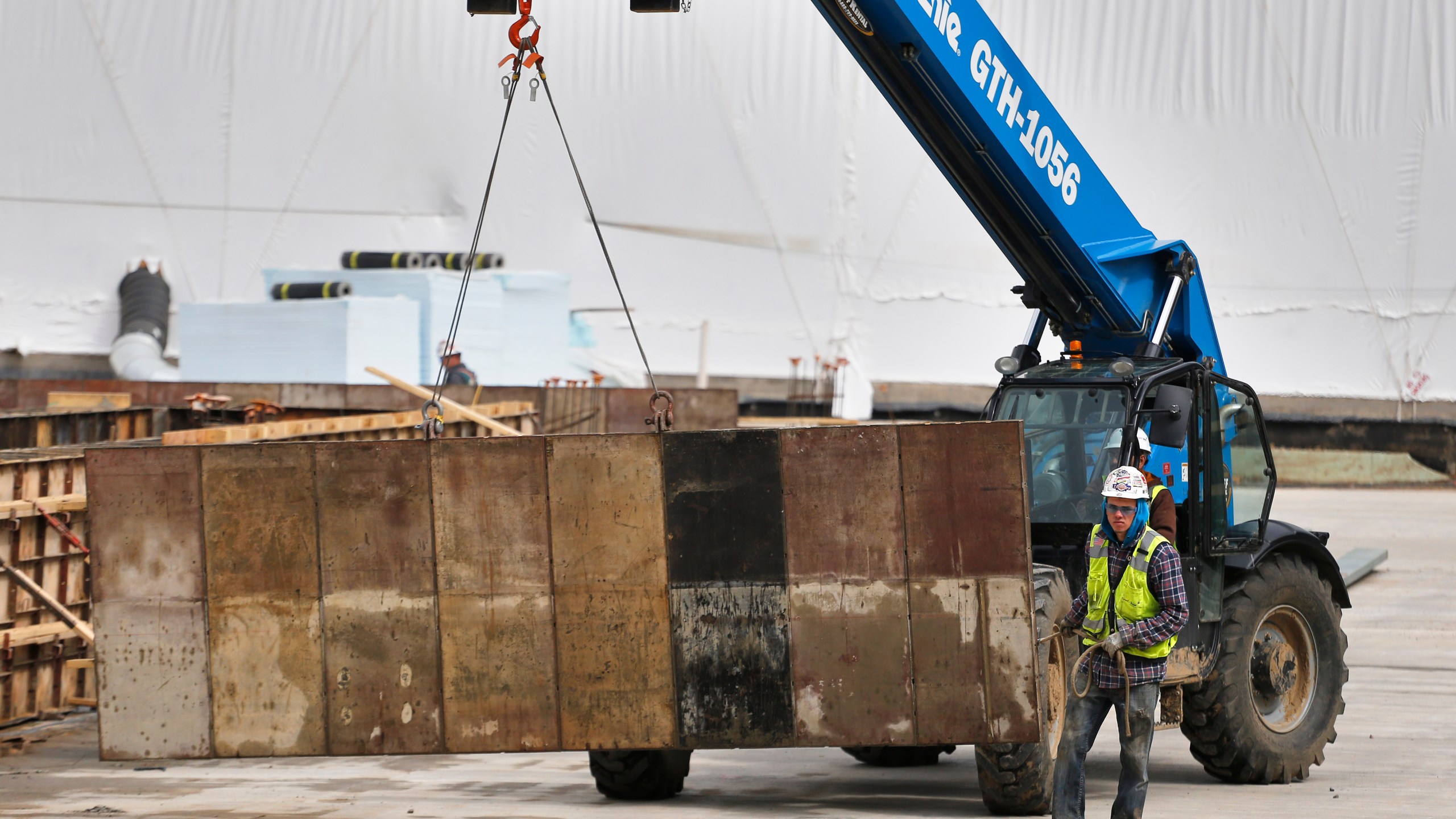 A construction crew works on concrete forms at the Veterans Administration hospital complex