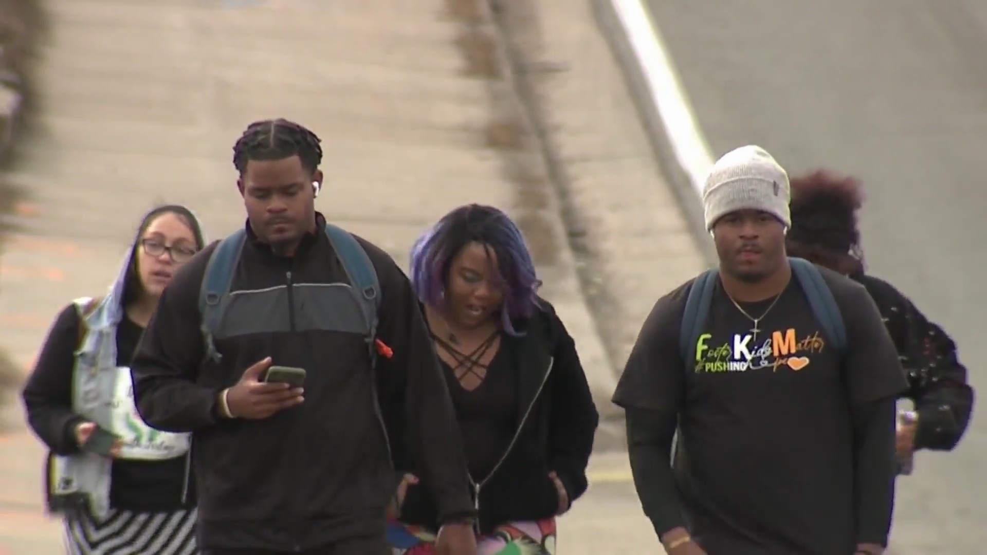 A group of young people walking together down a street