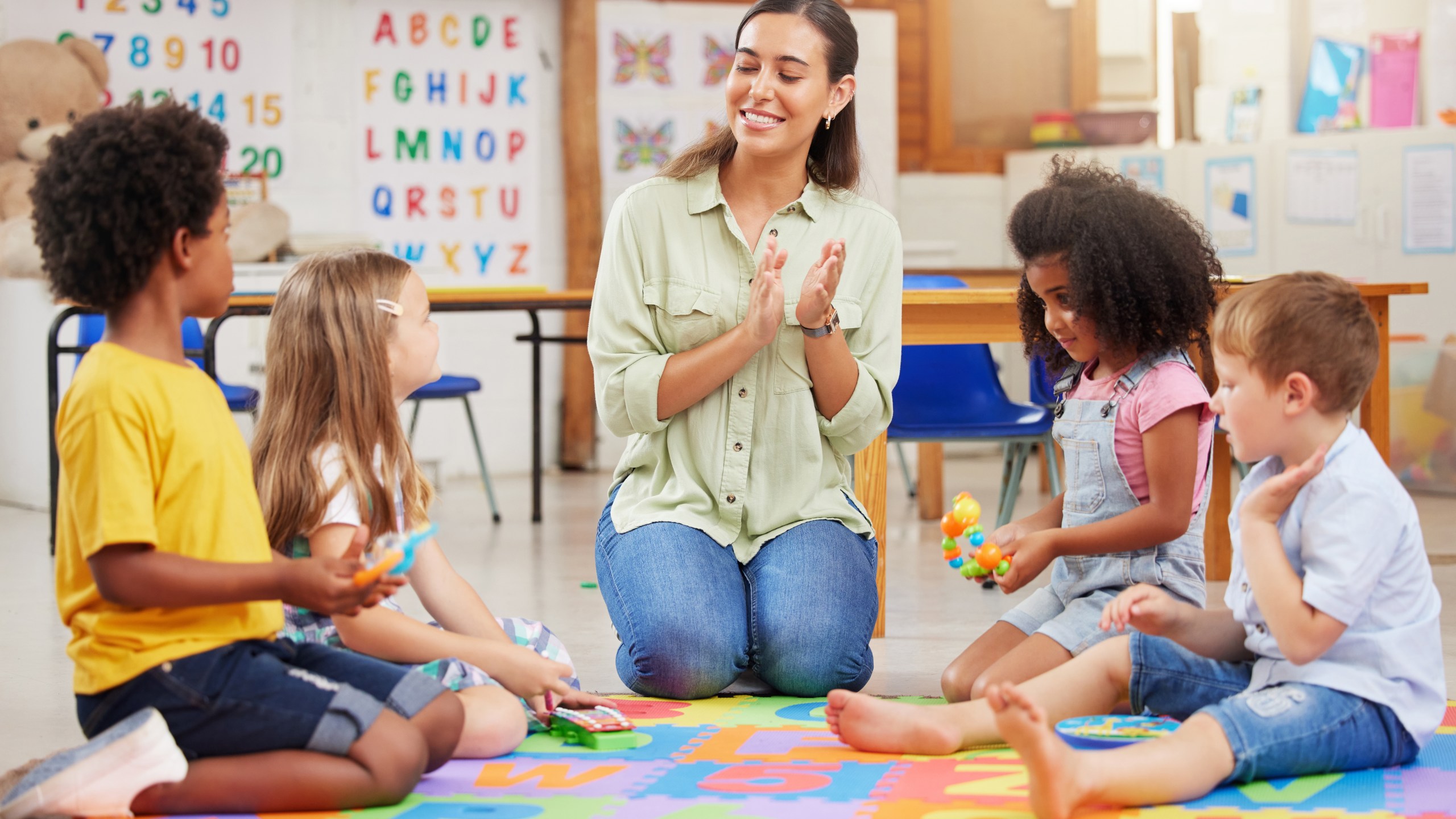 Shot of a teacher singing with her preschool children