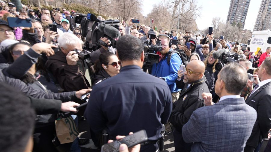 Denver Mayor Michael Hancock and Chief of Police Ron Thomas meet with concerned parents as they wait to be reunited with their children following a shooting at East High School,