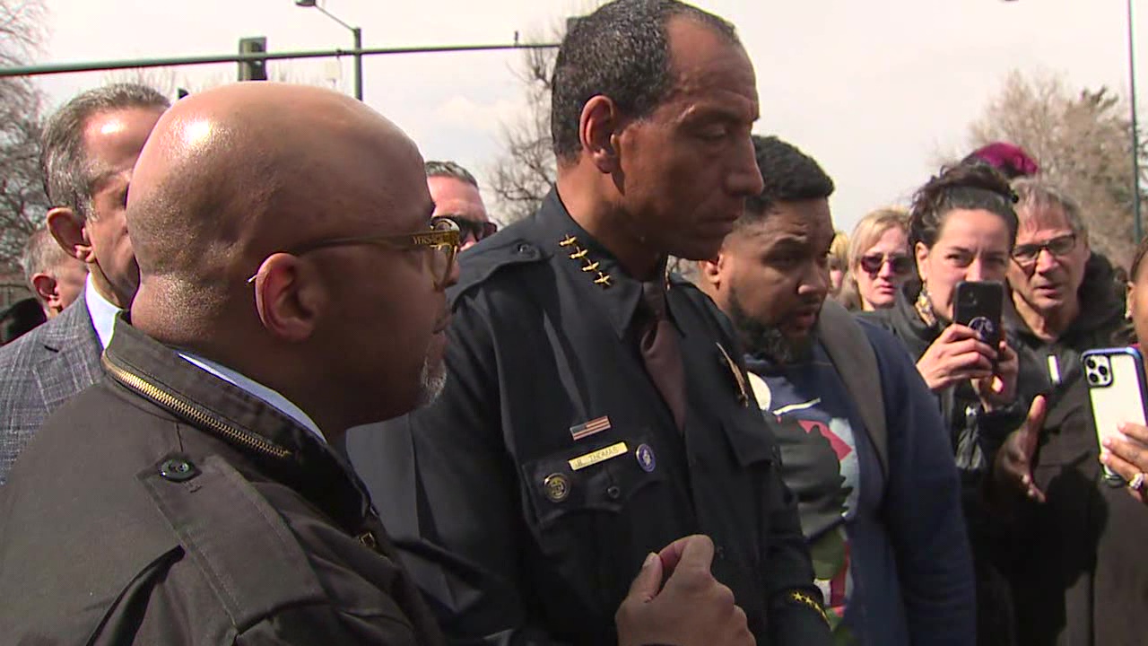 Denver Mayor Michael Hancock and and Chief of Police Ron Thomas talk with parents after a shooting at East High School on March 22, 2023.