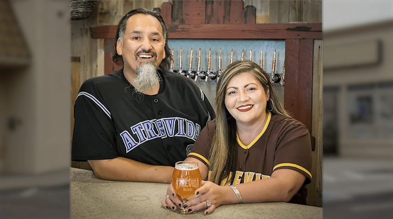 Richard and Jess Fierro pose for a portrait in front of beer taps