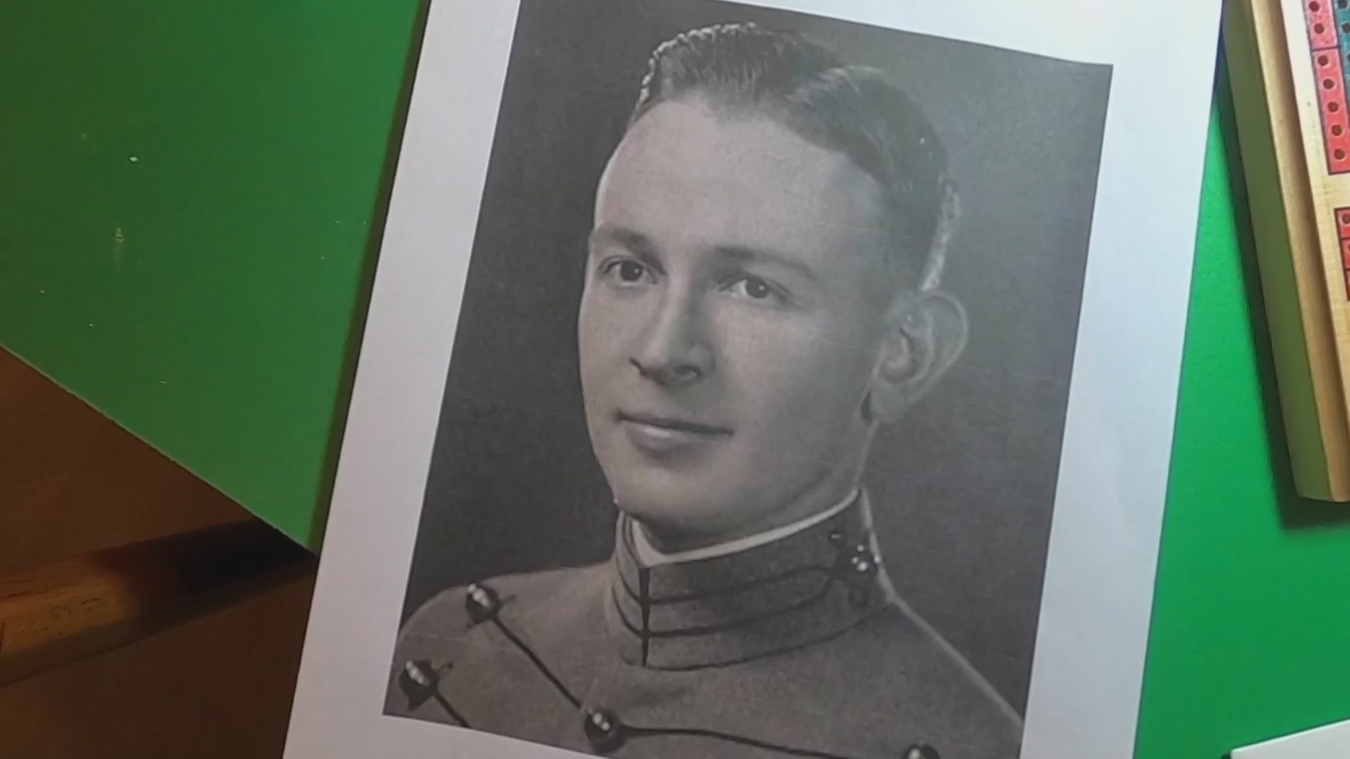 A black-and-white photo of a young man in military apparel