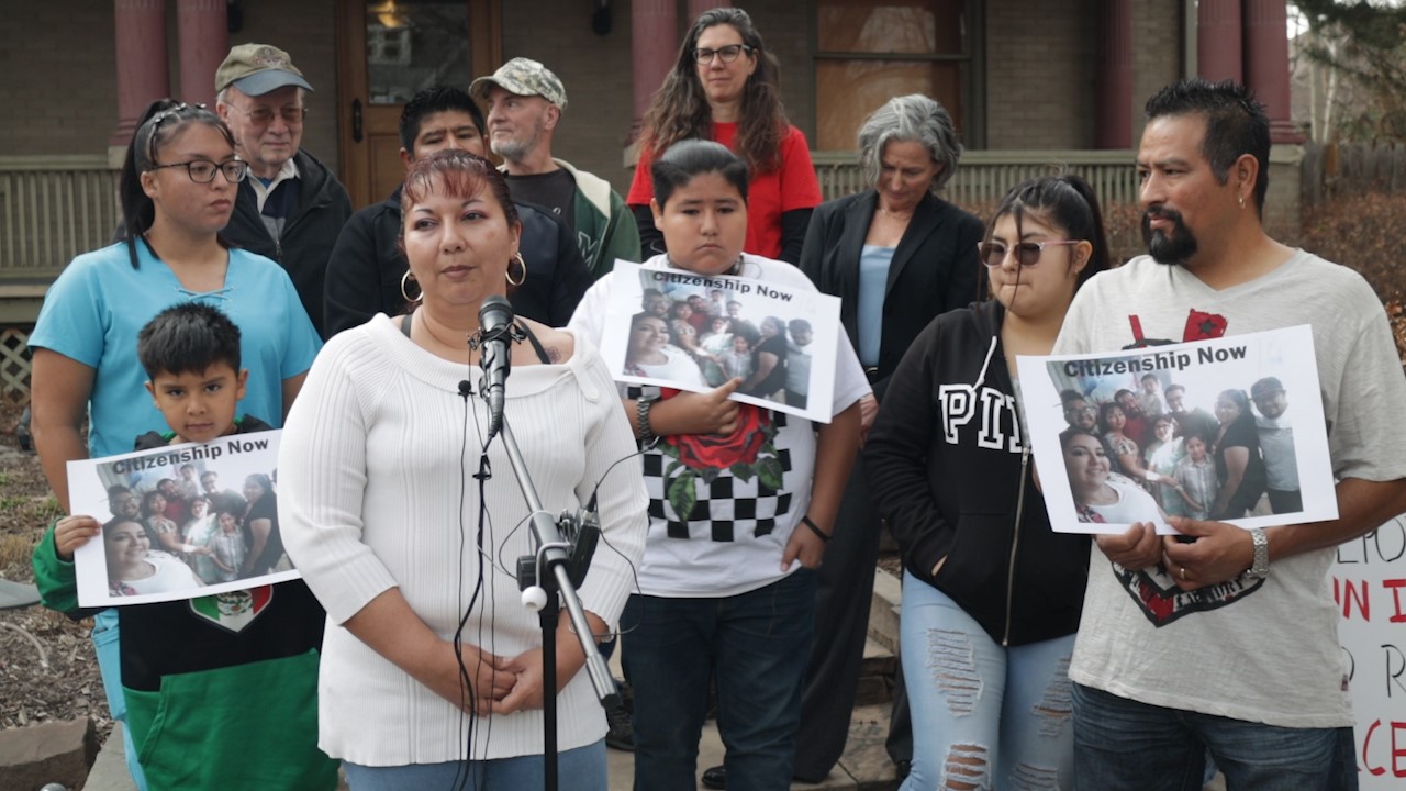 Jorge Zaldivar stands with his wife and children