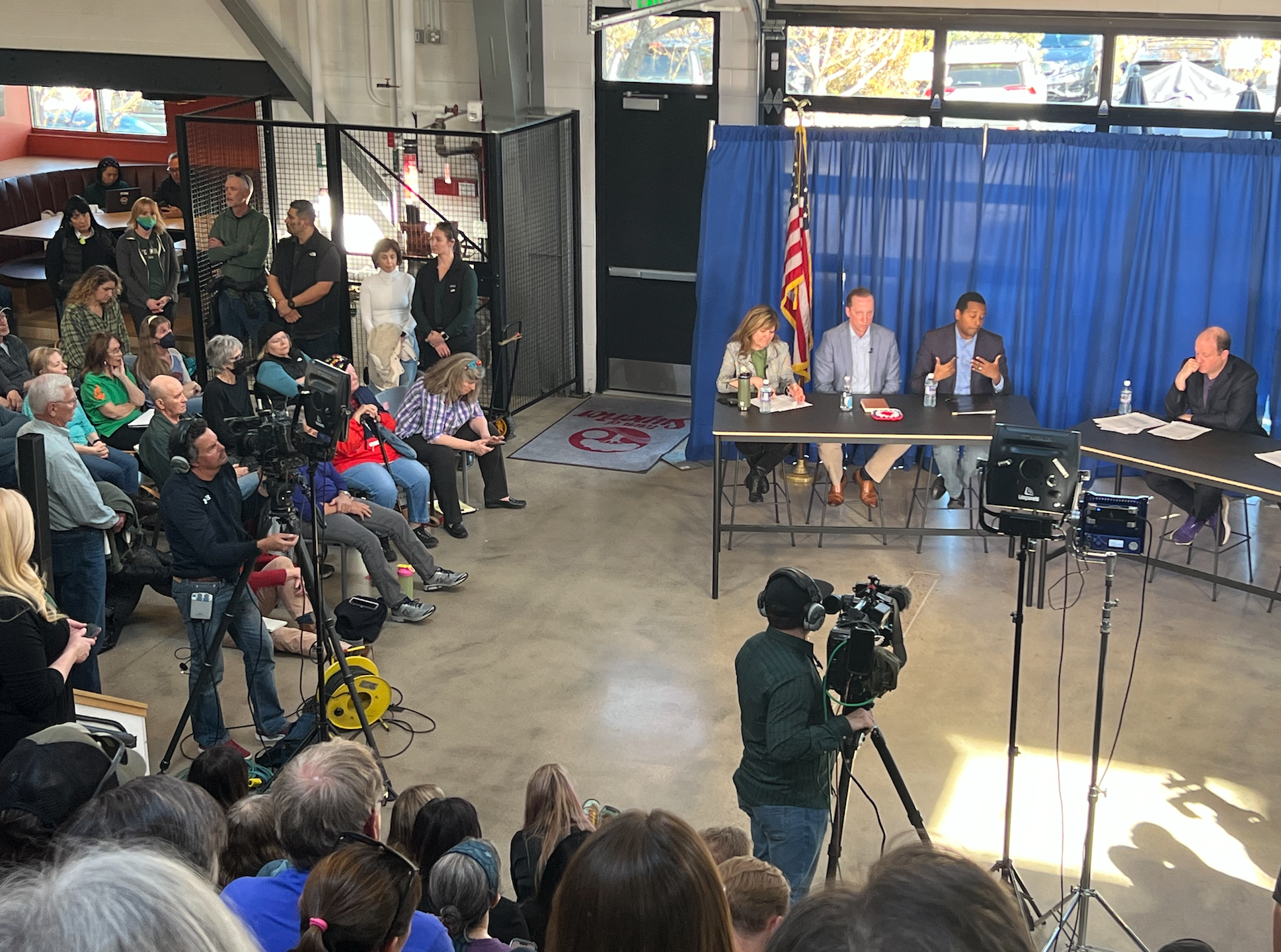 A crowd is seated around officials seated at a table