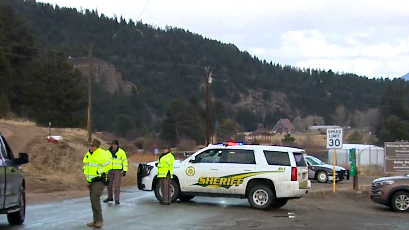 Authorities block a stretch of road near Bailey, CO. while looking for Austin Lyle, the suspect in the latest Denver East High School shooting incident.