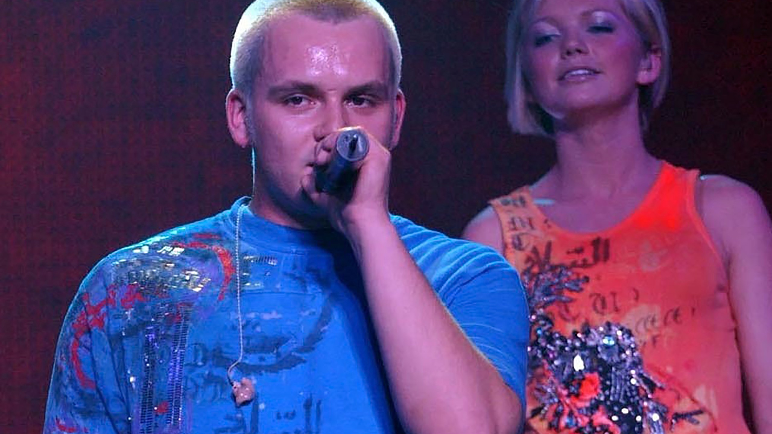 FILE - Paul Cattermole and fellow band mate Hannah looks on as they perform with pop group S Club 7 on stage at Wembley Arena in London, Feb. 14, 2002. Cattermole, a member of early-2000s British pop group S Club 7, has died at the age of 46, it was announced Friday, April 7, 2023. The news comes just weeks after the band announced a reunion tour. (Yui Mok/PA via AP, file)