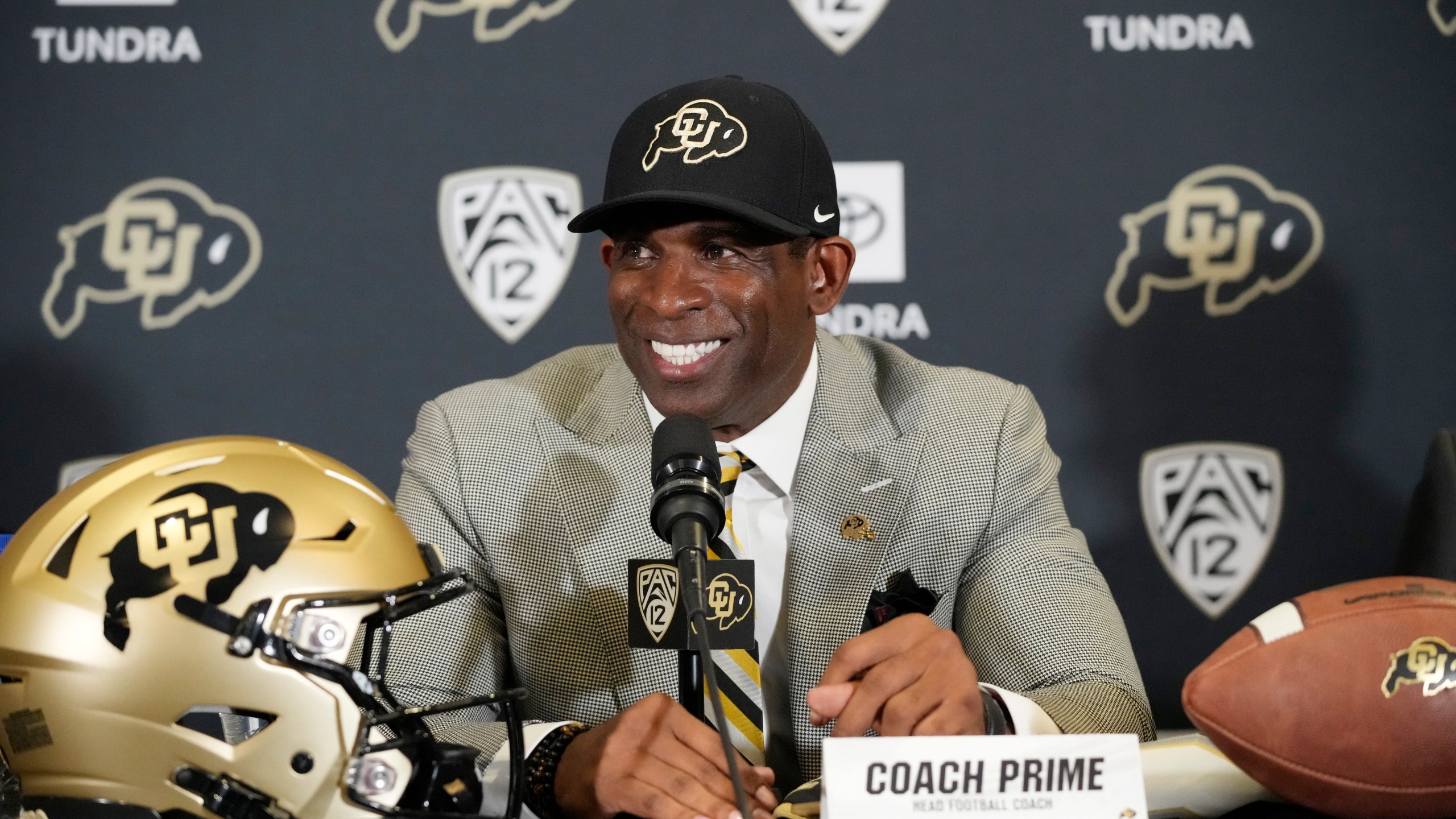 FILE - Deion Sanders speaks after being introduced as the new head football coach at the University of Colorado during a news conference Sunday, Dec. 4, 2022, in Boulder, Colo. Hired in December after a highly successful run as Jackson State’s head coach, the NFL Hall of Fame cornerback known for his playmaking and pizzazz, is in the midst of running practices with his new team. (AP Photo/David Zalubowski, File)