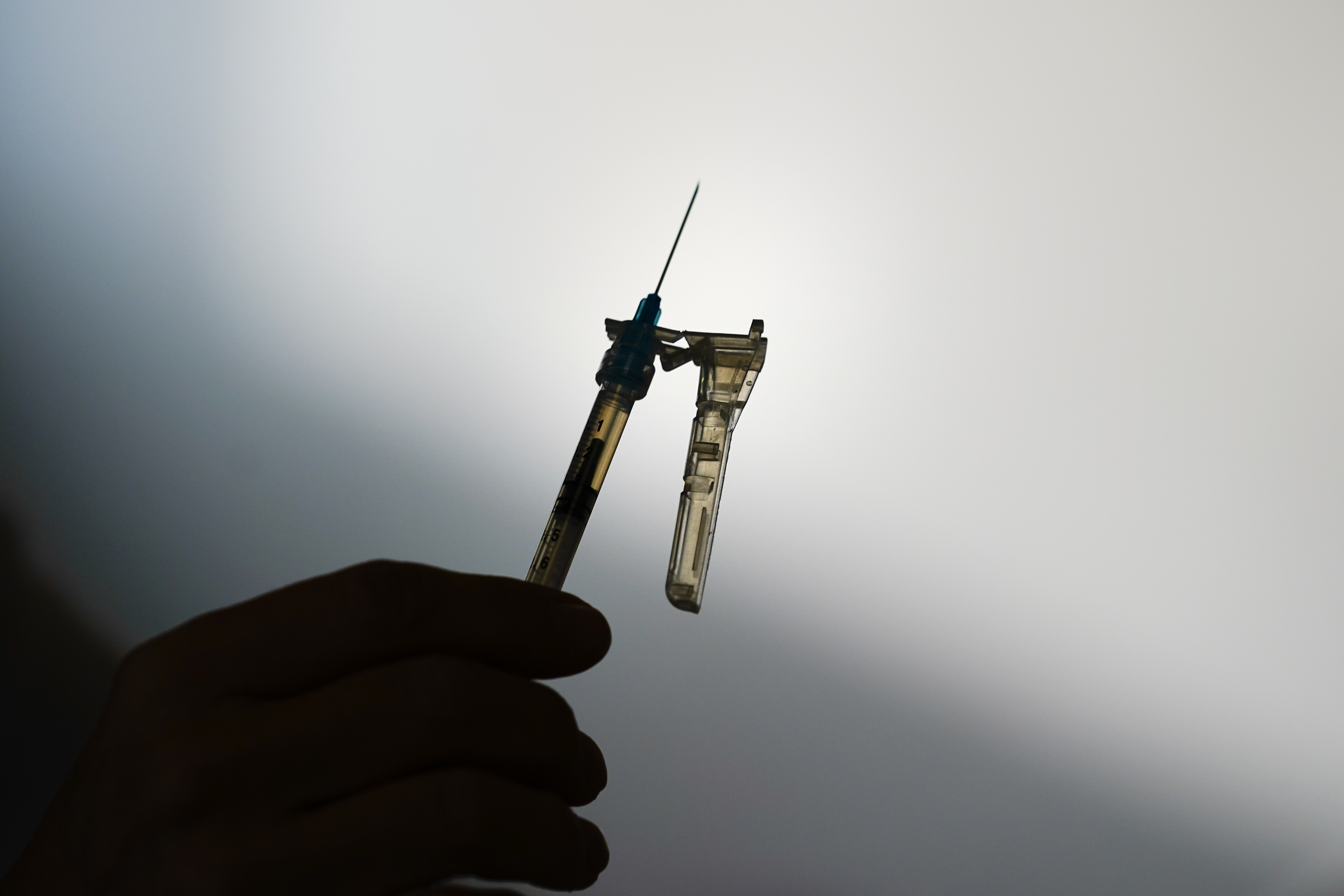 FILE - A syringe is prepared at a clinic in Norristown, Pa., Dec. 7, 2021. The Environmental Protection Agency proposed Tuesday, April 11, 2023, to limit the use of the chemical ethylene oxide after finding higher than expected cancer risk at facilities that use it to sterilize billions of medical devices each year. (AP Photo/Matt Rourke, File)