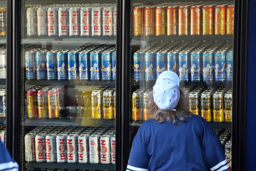 A baseball fan looks at the offerings in a beer cooler at PNC Park before a baseball game between the Pittsburgh Pirates and the Houston Astros in Pittsburgh, Wednesday, April 12, 2023. (AP Photo/Gene J. Puskar)