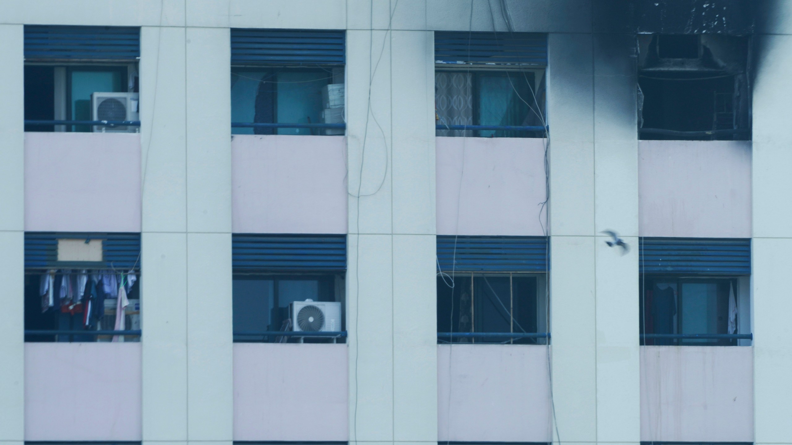 Char marks are seen after an apartment fire in Dubai, United Arab Emirates, Sunday, April 16, 2023. A fire swept through an apartment building in an older neighborhood of Dubai in the United Arab Emirates, killing multiple people and injuring another several, authorities said Sunday. (AP Photo/Jon Gambrell)