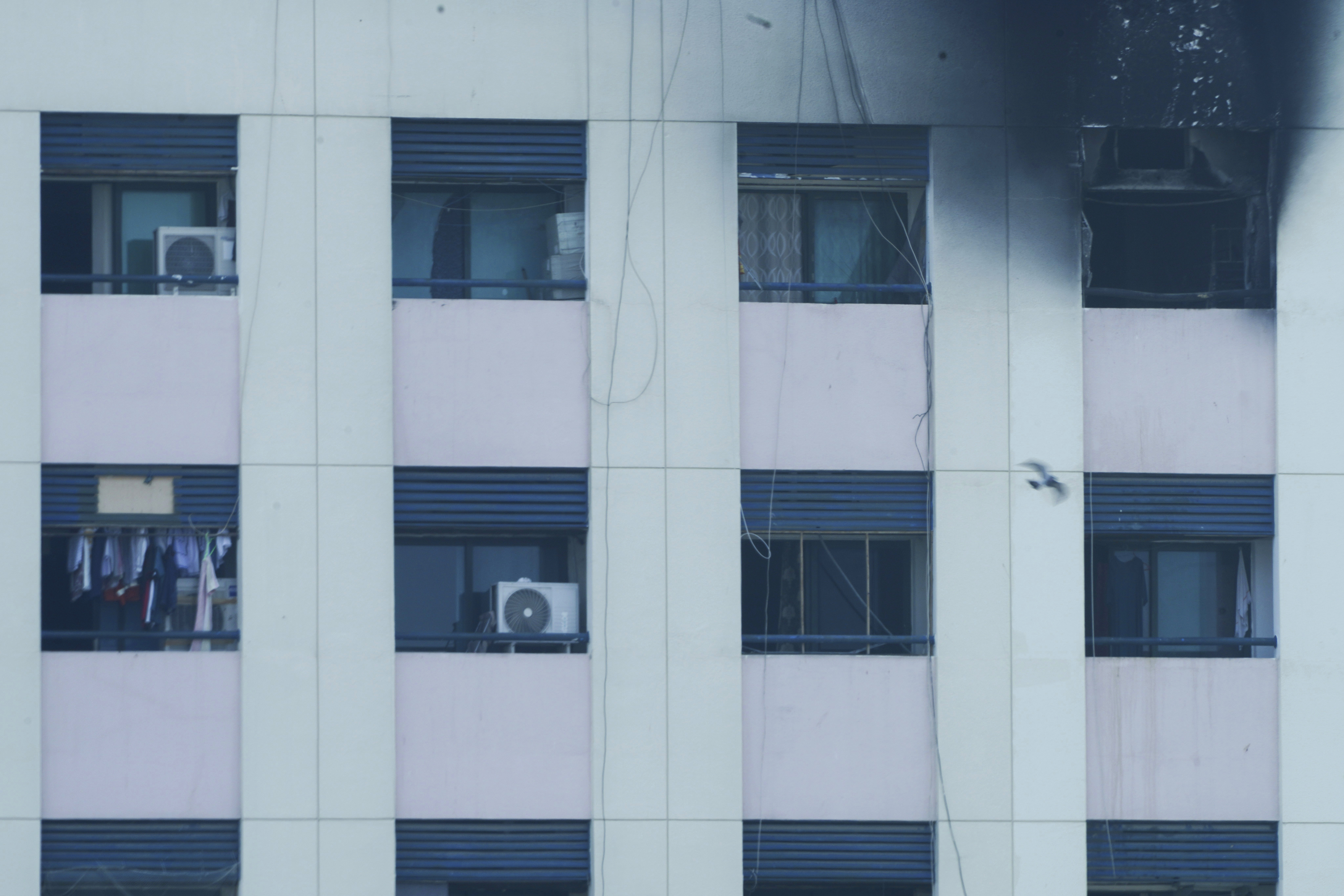 Char marks are seen after an apartment fire in Dubai, United Arab Emirates, Sunday, April 16, 2023. A fire swept through an apartment building in an older neighborhood of Dubai in the United Arab Emirates, killing multiple people and injuring another several, authorities said Sunday. (AP Photo/Jon Gambrell)