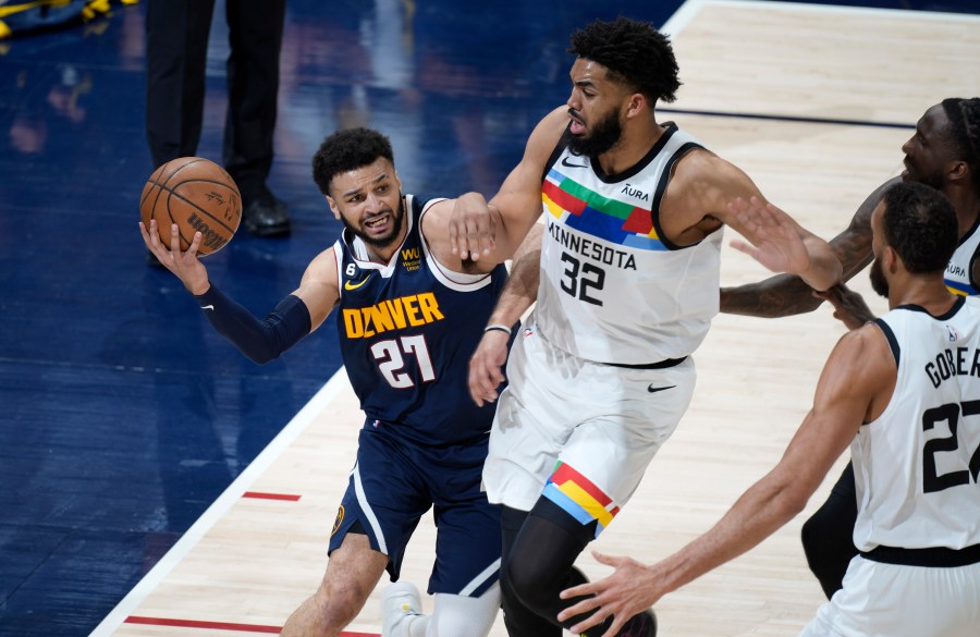 Denver Nuggets guard Jamal Murray, left, is defended by Minnesota Timberwolves center Karl-Anthony Towns during the first half of Game 2 in an NBA basketball first-round playoff series Wednesday, April 19, 2023, in Denver. (AP Photo/David Zalubowski)