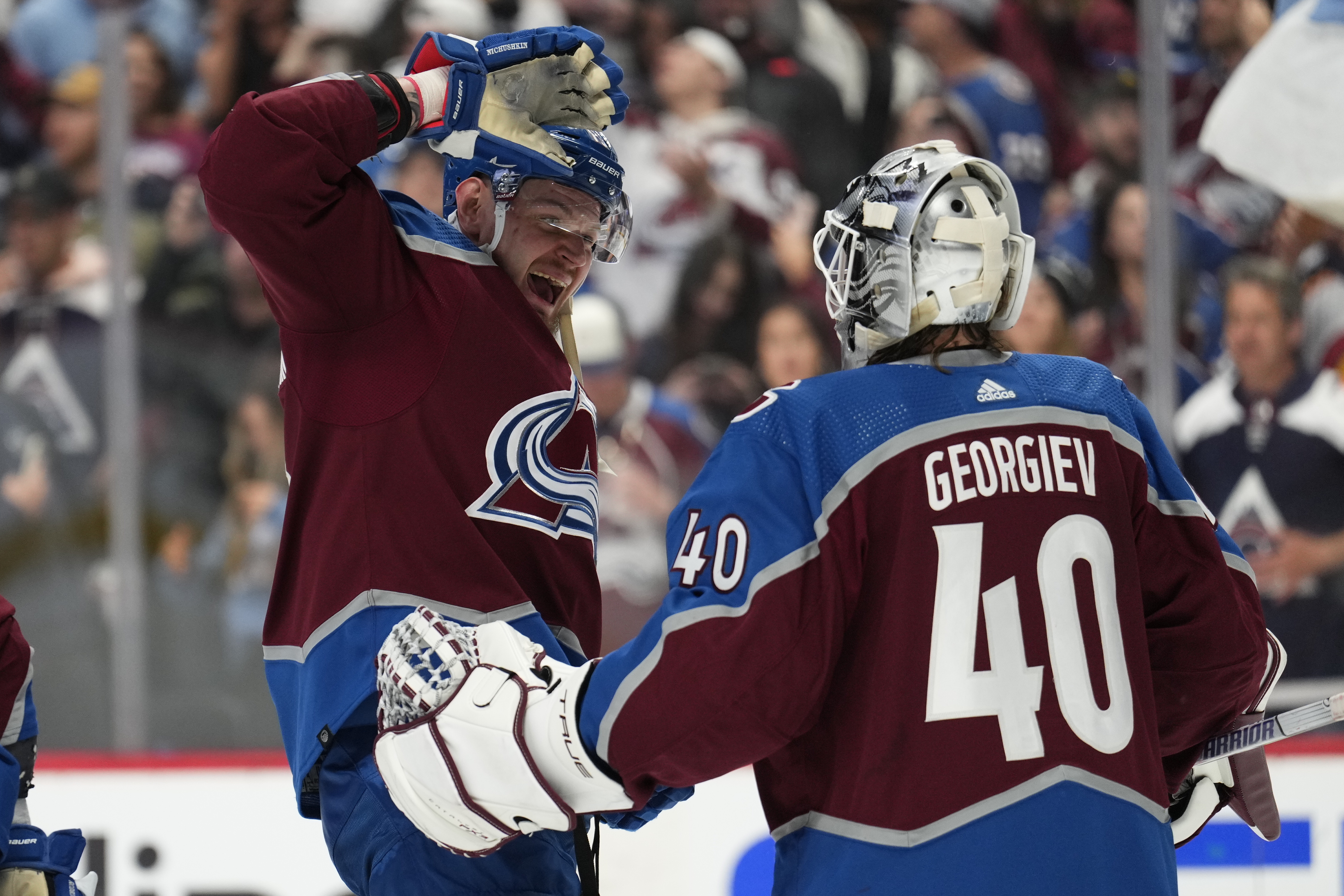 Colorado Avalanche right wing Valeri Nichushkin (13) and goaltender Alexandar Georgiev celebrate the team's 3-2 win against the Seattle Kraken in Game 2 of a first-round NHL hockey playoff series Thursday, April 20, 2023, in Denver. (AP Photo/Jack Dempsey)