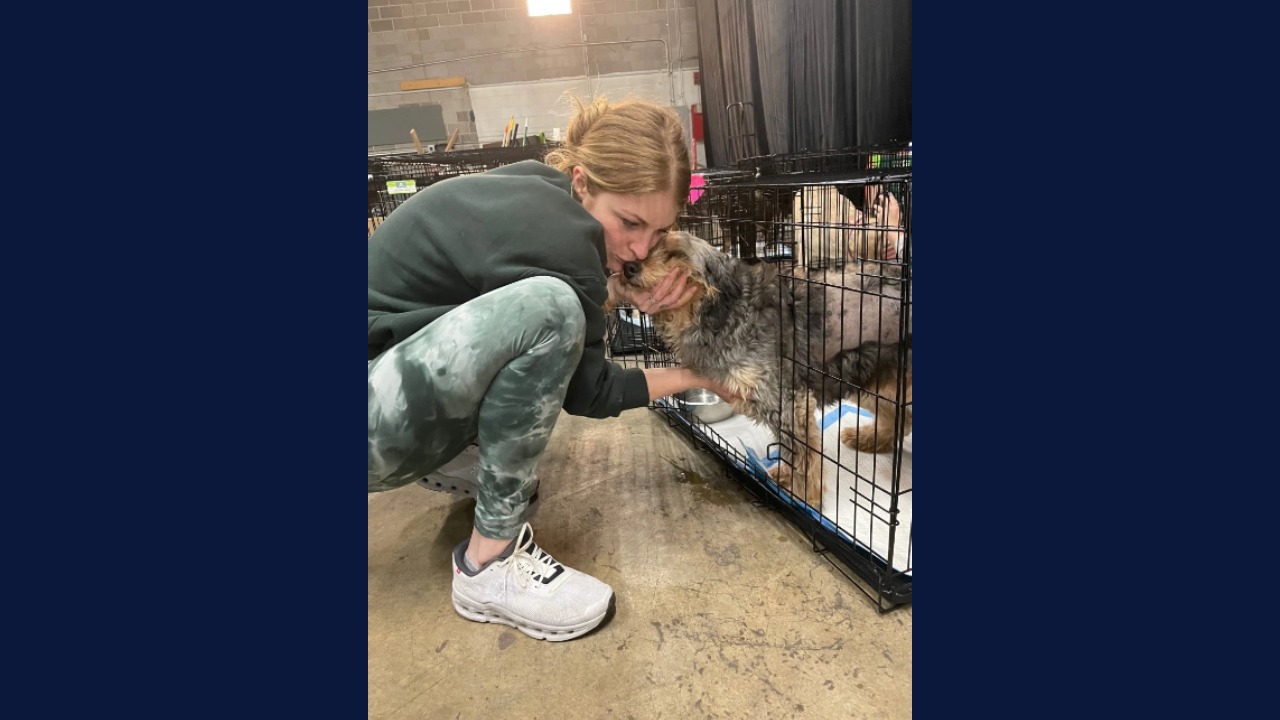 A woman hugs a dog