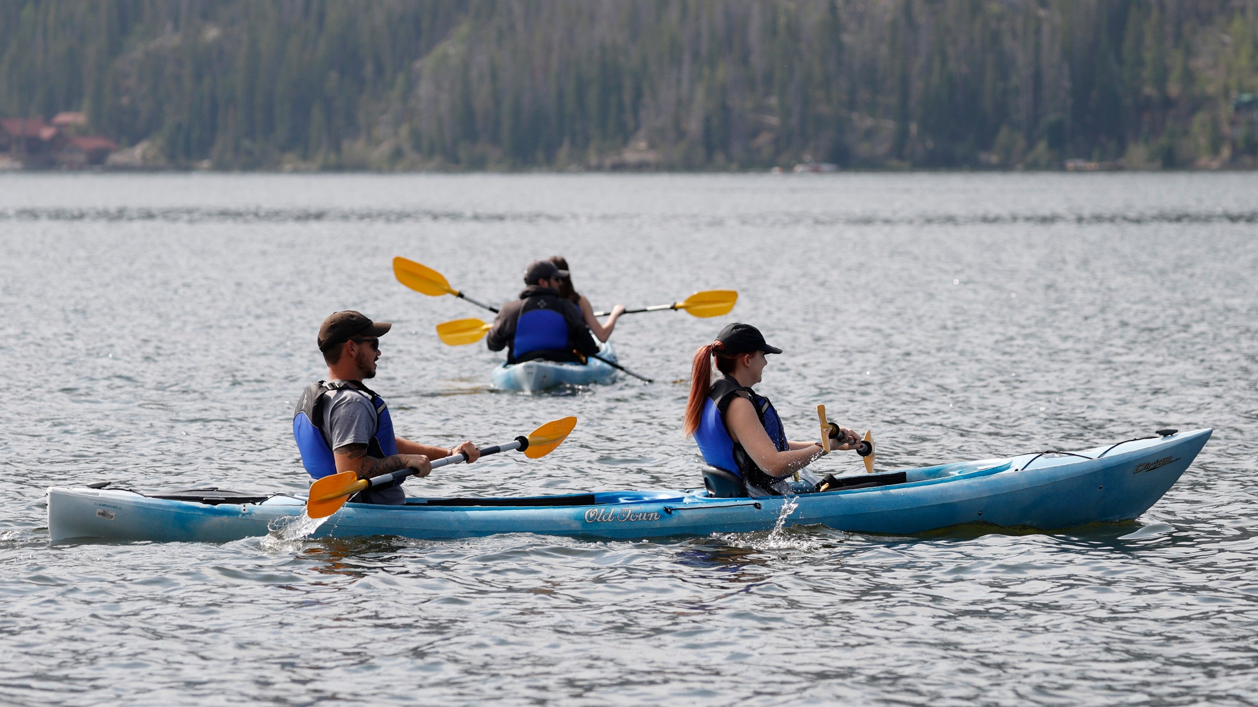 Kayakers ply the choppy waters of Grand Lake