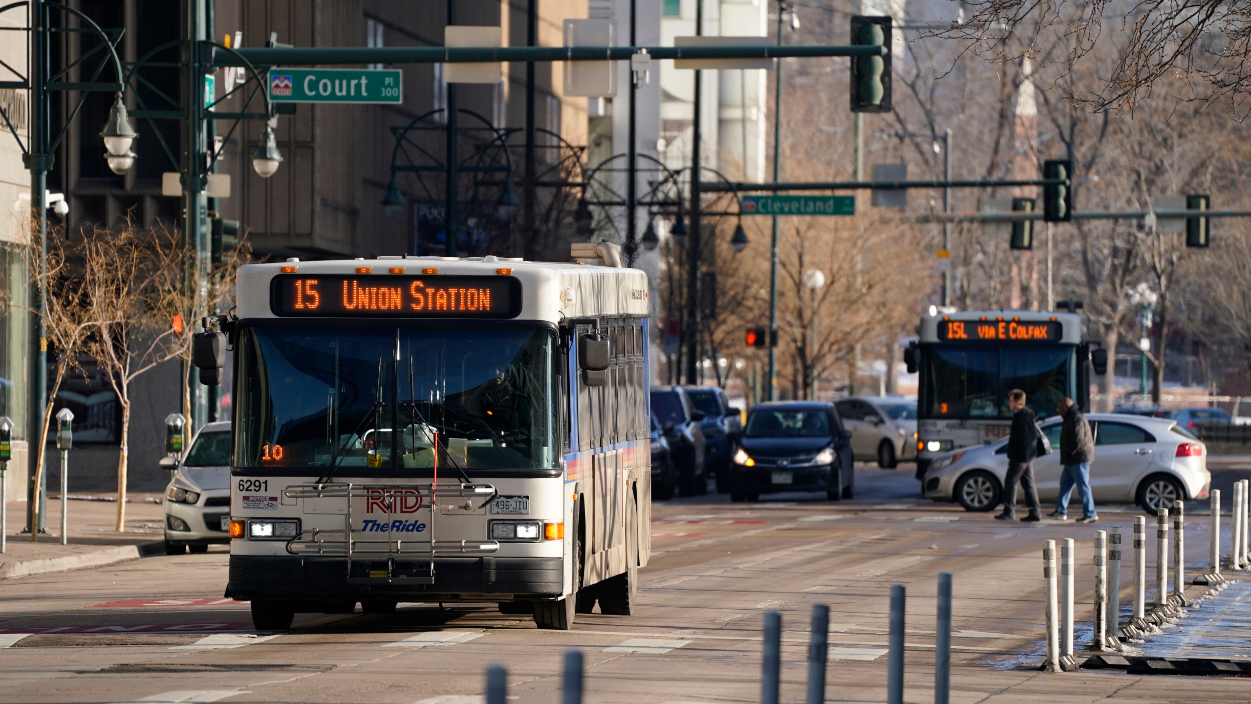 A Regional Transportation District bus moves along 15th Street