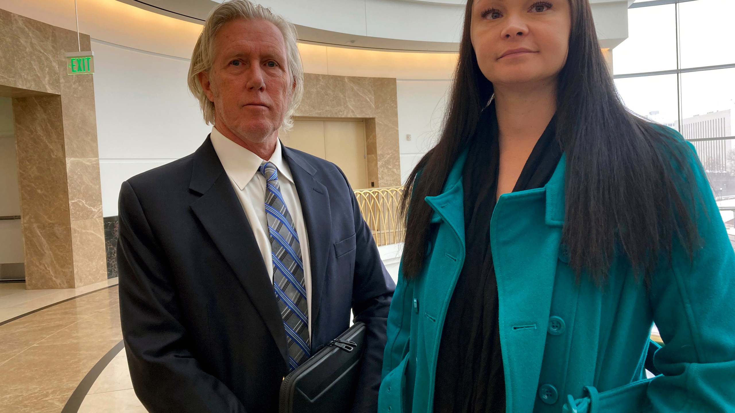 Lawyer James Avery, left, and his client Angelica Saupe pose for a photo at the Colorado Supreme Court