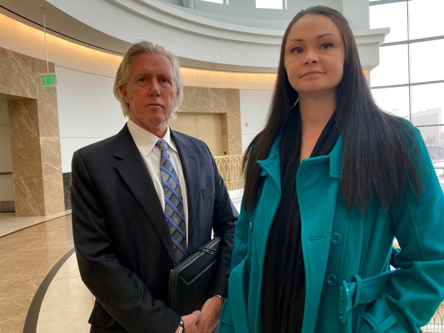 Lawyer James Avery, left, and his client Angelica Saupe pose for a photo at the Colorado Supreme Court