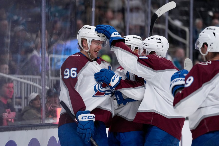 Colorado Avalanche right wing Mikko Rantanen, left, celebrates with teammates after scoring a goal